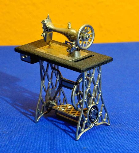 Metal model of a foot-operated table sewing machine