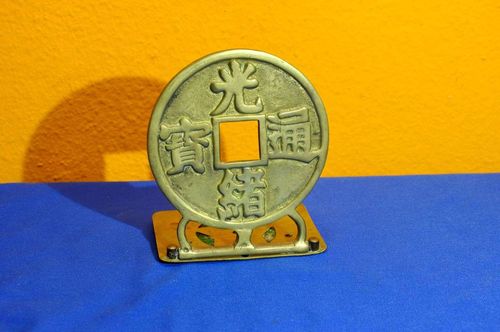 Brass bookend in the shape of a Japan Wado coin